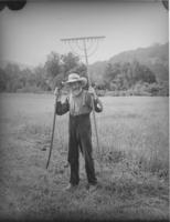 Unidentified farmer with rake
