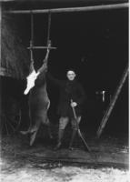 Howard Thayer, Porter Thayer's brother, with hanging deer, South Newfane, Vt.