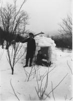 Webster and Ruth Thayer, Porter Thayer's children, with snow house and skis