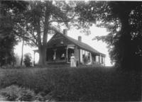 Unidentified house with woman and child in front