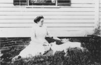 Lottie Williams with piglets on front lawn, Williamsville, Vt.