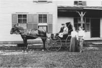 Two couple outside dwelling with horse and buggy, East Dover, Vt.