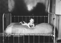 Thayer child on a bed