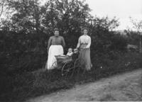 Two women and a baby in a stroller by the side of the road, Wardsboro, Vt.