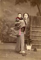 Woman carrying her child on her back